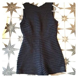 Black romper. NEVER WORN. STILL HAS TAGS
